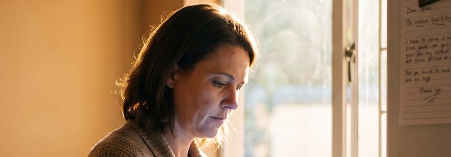A homeowner reading their solar report at the kitchen counter at dawn
